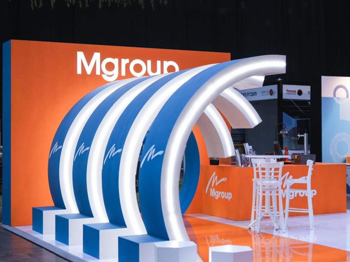 A fan of illuminated blue and white arcs rising from stepped plinths against an orange wall.