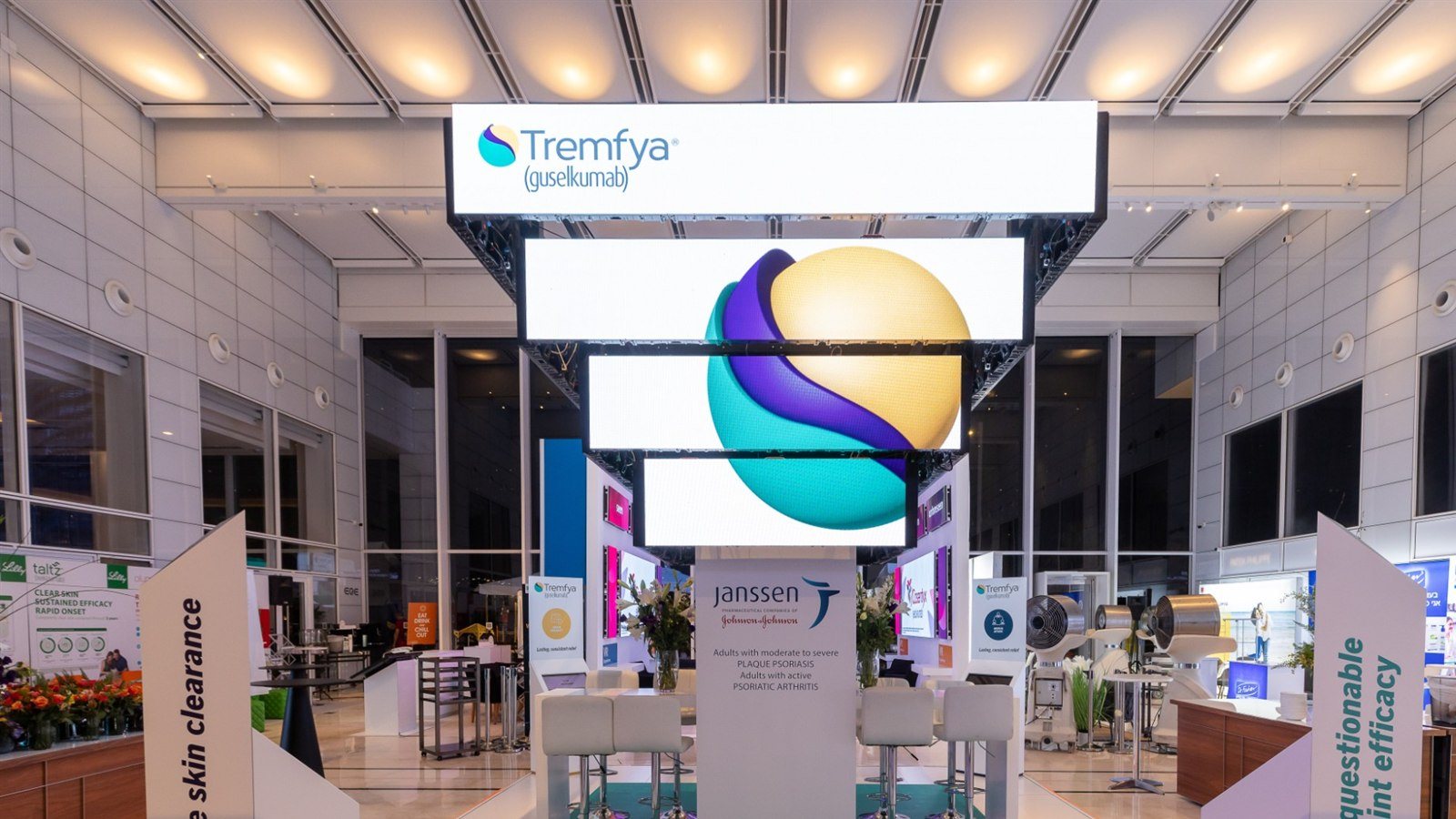 Stacked LED panels carrying one continuous graphic above an open stand, angled white fins either side.
